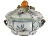 an image of a tureeny dish with an orange on top