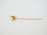 a small piece of gold on a white surface