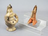 two figurines that are sitting on a clear shelf