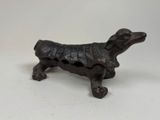 a small statue of a dog that is sitting on a table