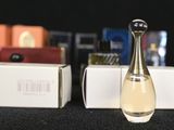 a bottle of perfume sitting on a table next to a box