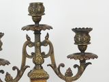 a three light candelier that is on a table