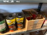 many cans of paint on a shelf next to a box