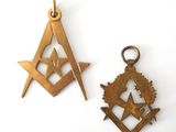 two masonic symbols are shown on a white surface