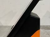 a tablet computer sitting on top of a black and orange stand