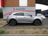 a silver car parked in front of a building