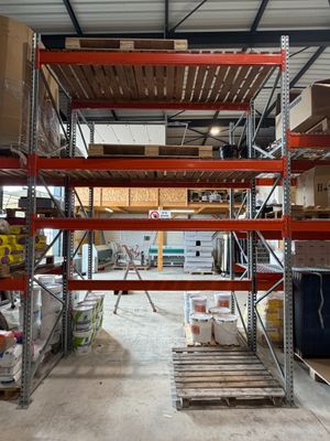 a large warehouse with a lot of shelves and pallets