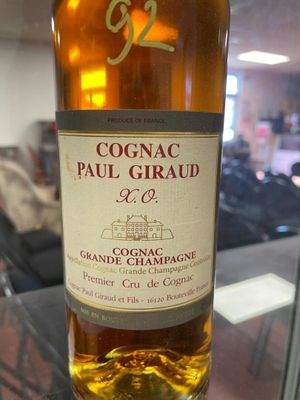 bottle of cognac paul giraud grand cru champagne on a glass table