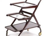 a three tiered serving cart with glass shelves on wheels