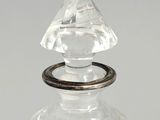 an antique glass decanter with a ring on top of it