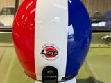 a red, white and blue helmet on display in a glass case