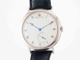 a close up of a wrist watch with a white dial and black leather strap