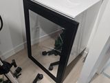 a mirror on the wall next to a bike in a room