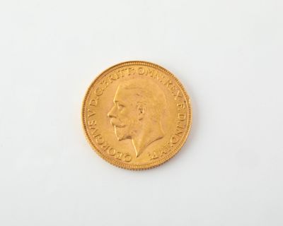 a close up of a gold coin on a white surface