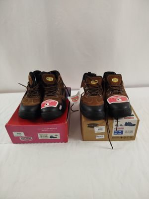 two pairs of brown work boots sitting on top of a box