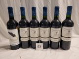 several bottles of wine are lined up on a table