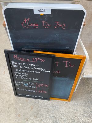 a chalk board with a menu on it next to a chalk board with a menu written on it