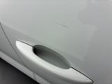 a close up of a door handle on a white car
