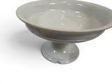a white bowl on a pedestal on a white background
