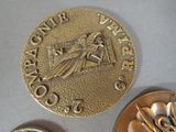 a gold medal and a silver medal sitting on a table