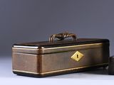 pair of antique suitcases with handles on a grey background