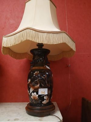 a lamp that is on a table with a lamp shade on it