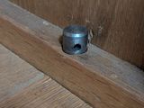 a close up of a piece of wood with a screw on it