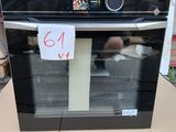 a black and white oven sitting on top of a cardboard box