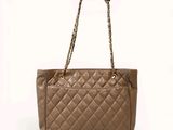 a chanel bag with a chain handle and shoulder strap