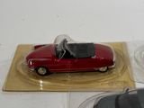 a red car that is sitting on top of a clear plate