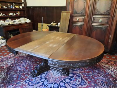 a large wooden table with two leaves on top of it