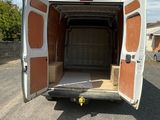 a white van with a brown door open on the street