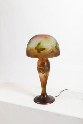 a lamp that is sitting on a shelf next to a wall