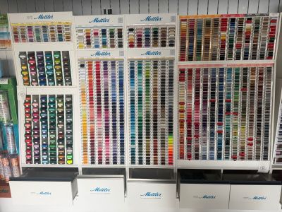 many different colors of paint on the shelves in the store