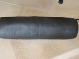 a black leather case sitting on a tiled floor