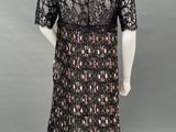 a mannequin dress with black lace and pink flowers