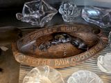 a wooden plaque with a picture of a lizard on it