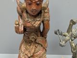 two figurines that are on display on a table