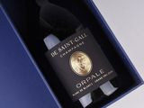 a bottle of wine in a blue box on a table