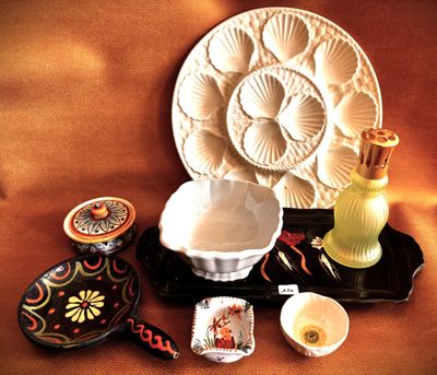 a plate, bowl, candle, and other items on a table