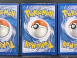 three packs of pokemon cards are sitting on top of a table