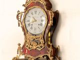 a clock hanging on the wall with a white background