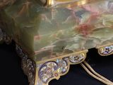 a gold and green lamp with a horse on it