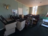 a room with a lot of chairs and a television on the wall