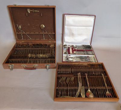 two wooden cases with silverware in them on a table