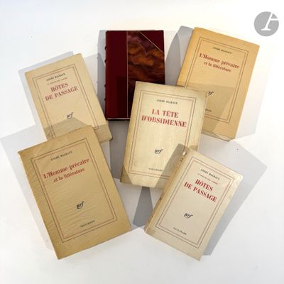 several books are stacked on top of each other on a white surface