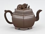 an image of a brown teapot with a bear on top of it