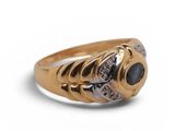 a close up of a gold ring with a blue stone