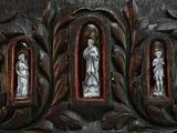 three statues of jesus and a woman in a wood frame
