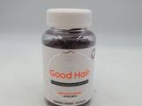 un gros plan sur un flacon de « Good Hair » muni d'un bouchon blanc